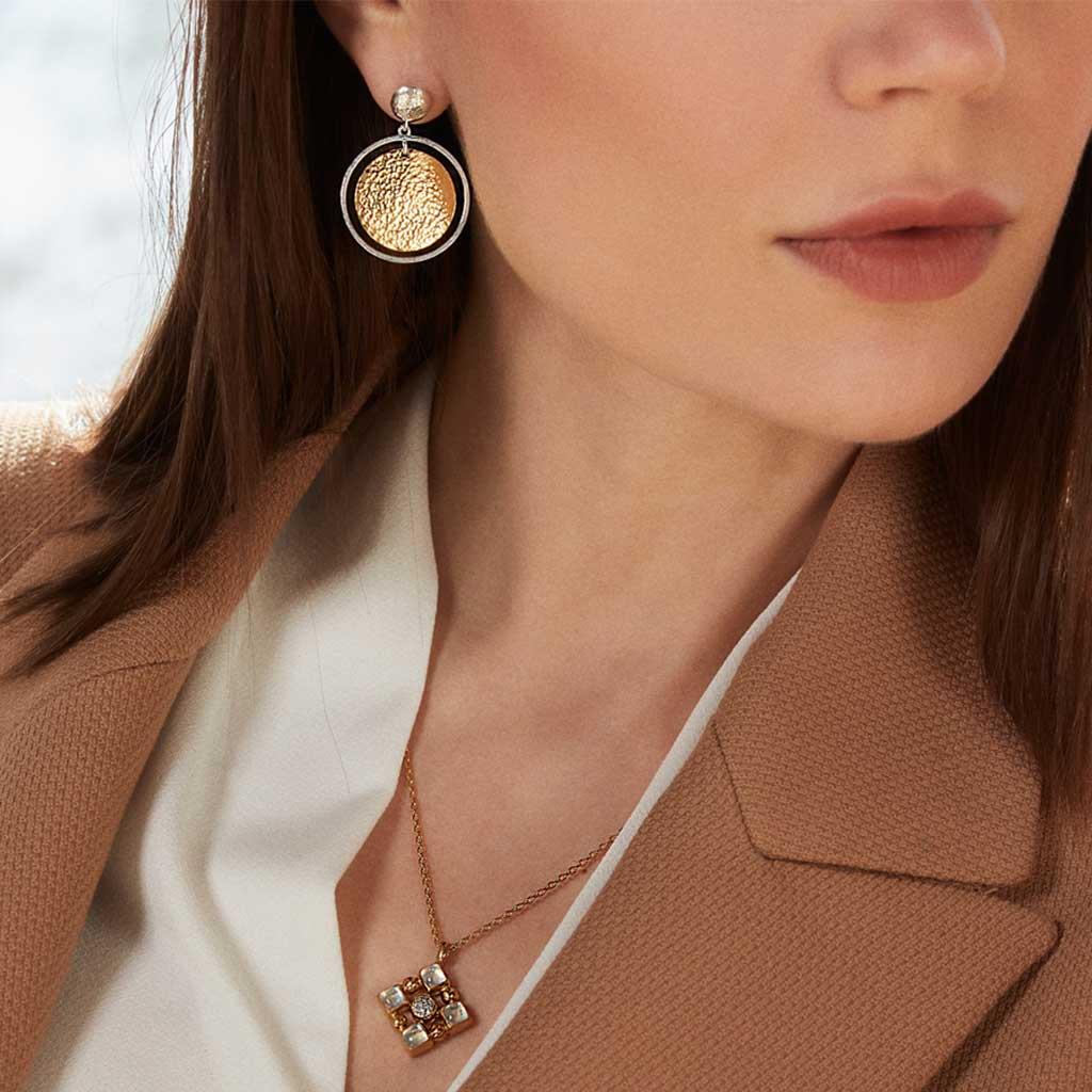 Gurhan Flake two-toned earrings on model in Amarillo, Tx