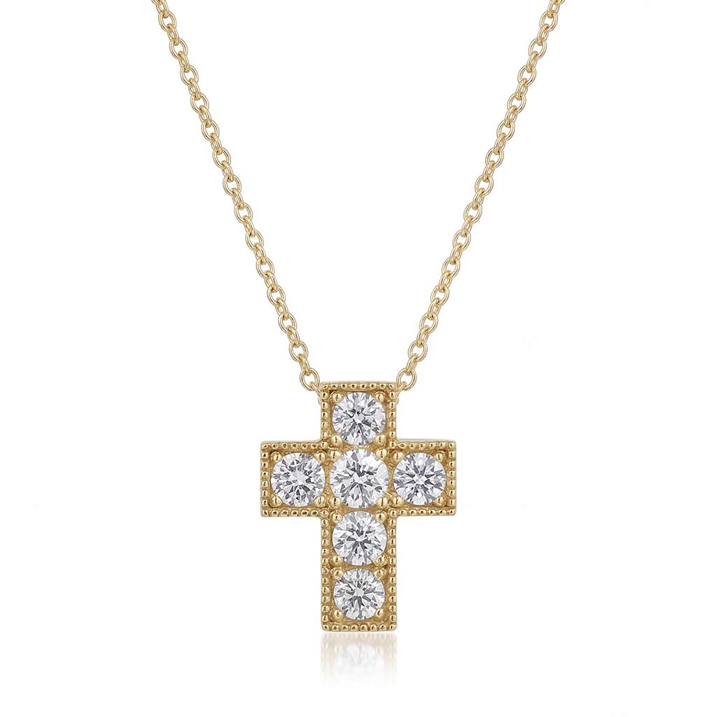 A yellow gold cross pendant necklace with round-cut diamonds with milgrain edges