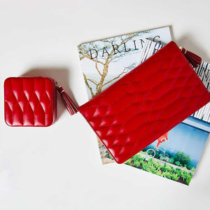 Caroline red jewelry travel cases on magazine