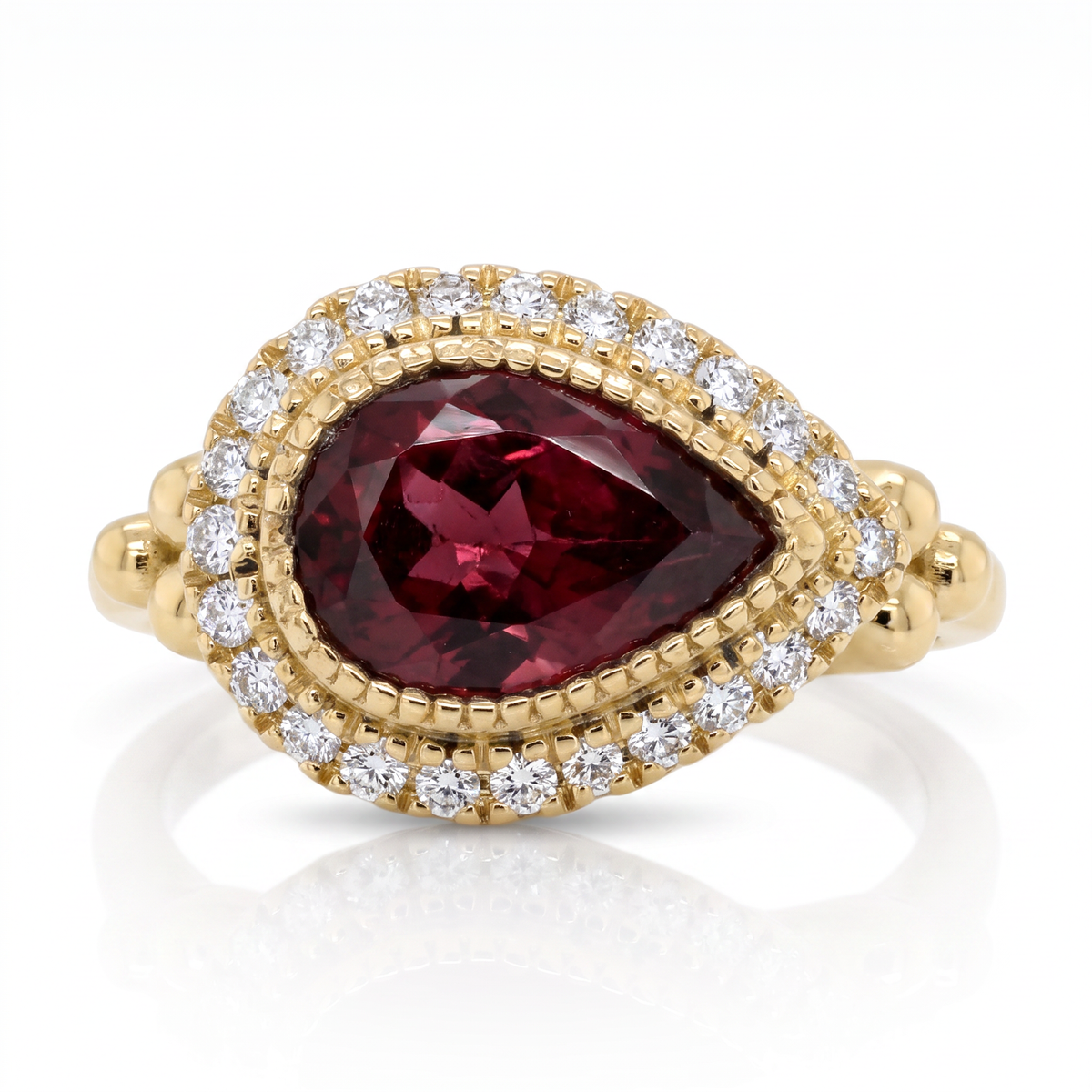 14K yellow gold raspberry tourmaline and diamond halo ring by Raymond Mazza available at Victoria Jones Jewelry in Amarillo, Texas.