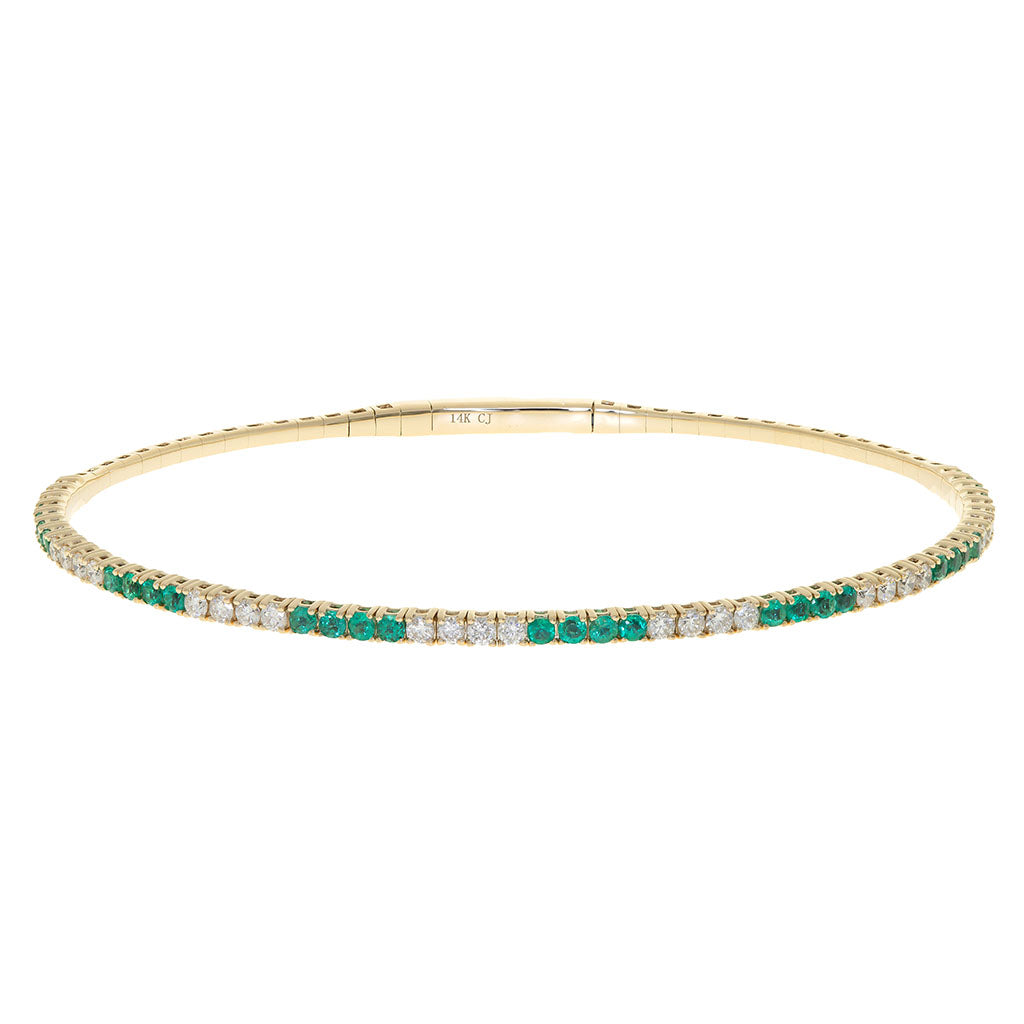 Emerald and diamond tennis style flex bangle bracelet in yellow gold