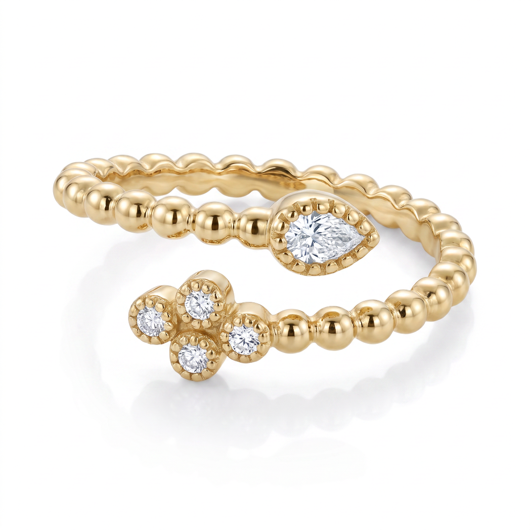 14K yellow gold diamond bypass ring with a pear-shaped diamond, round diamond cluster, and beaded shank by Raymond Mazza.