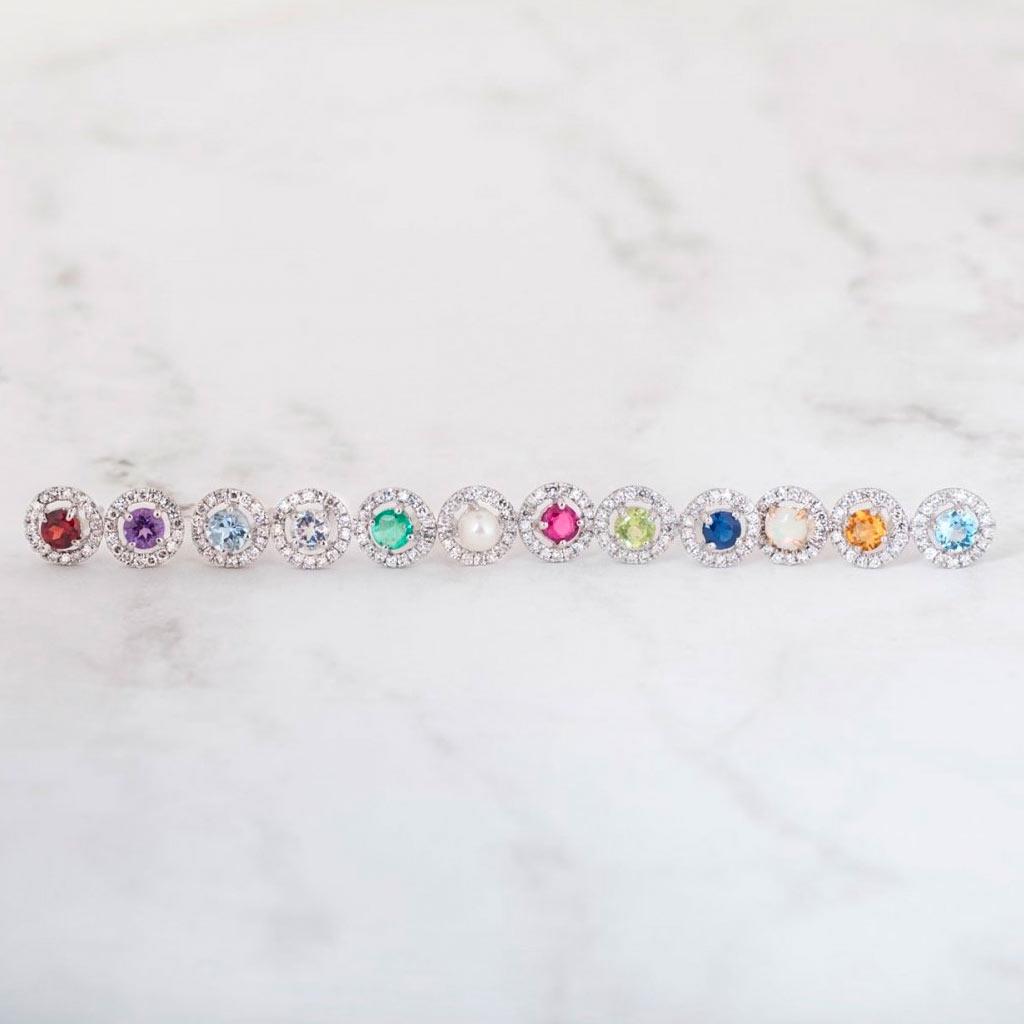 birthstone halo diamond earring studs in a line at Victoria Jones Jewelry Amarillo