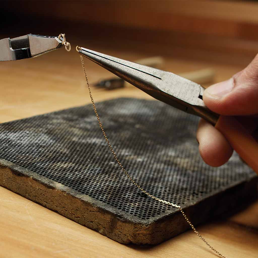 jeweler repairing chain
