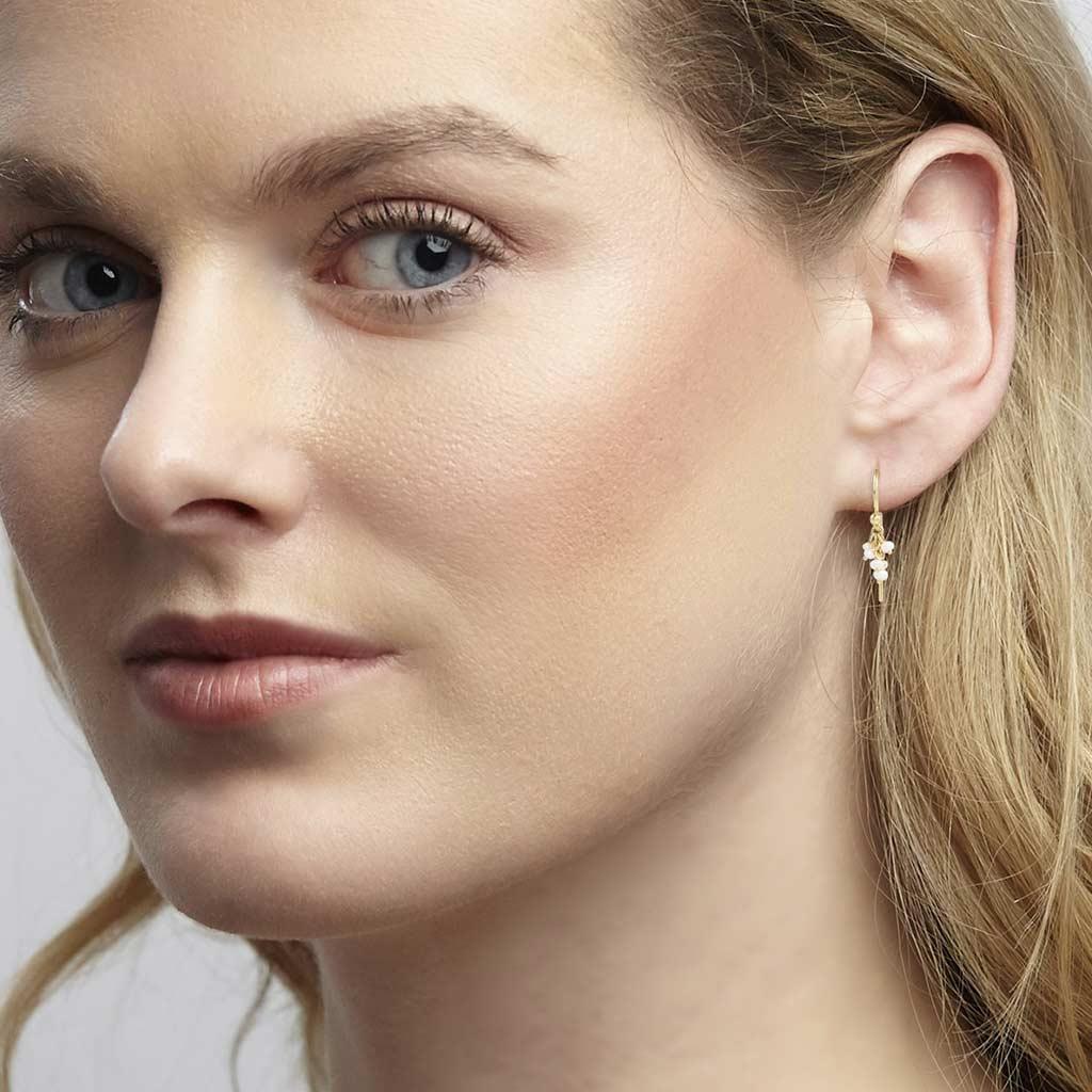 Gurhan pearl dangle earrings on ear at Victoria Jones Jewelry Amarillo