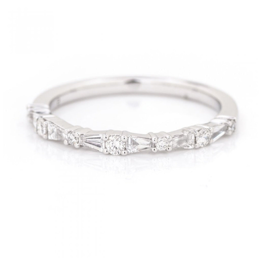 delicate diamond stacking band white gold baguette and round diamonds close up