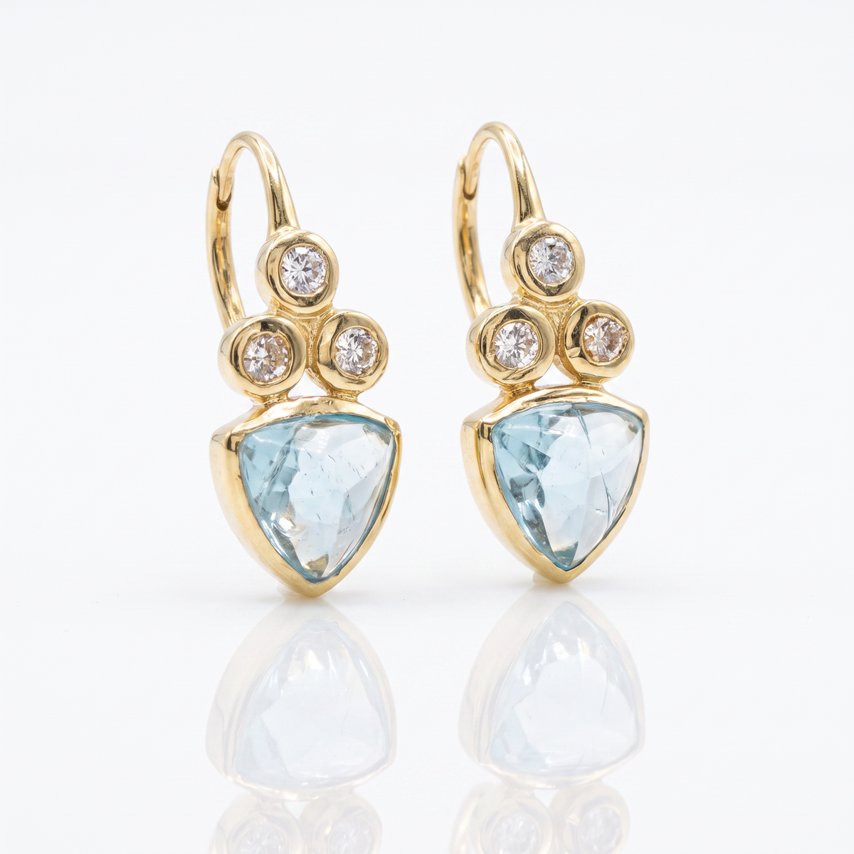 14K yellow gold trillion-cut apatite and diamond dangle earrings with shepherd hook closures by Raymond Mazza.