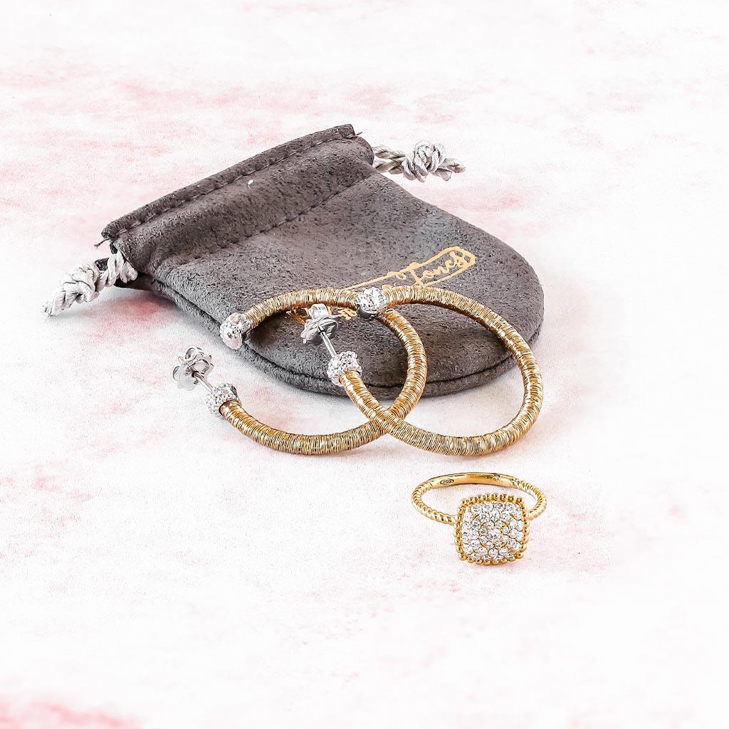 Gold hoop earrings and diamond ring displayed in Victoria Jones Jewelry showroom Amarillo